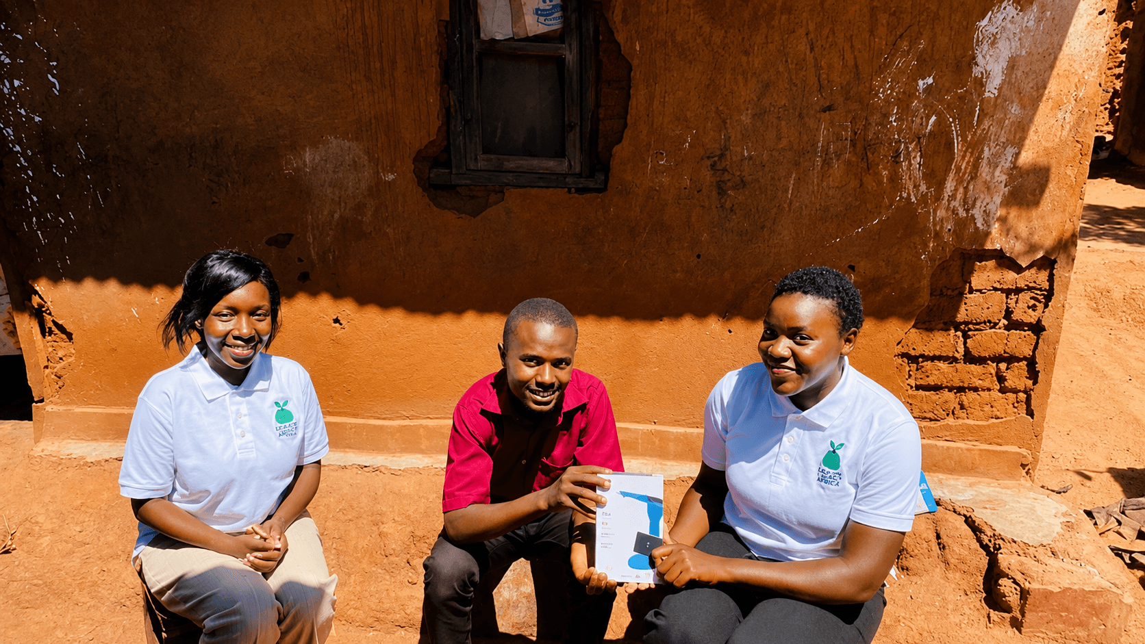 Green Minds team handing a solar lamp to a community member