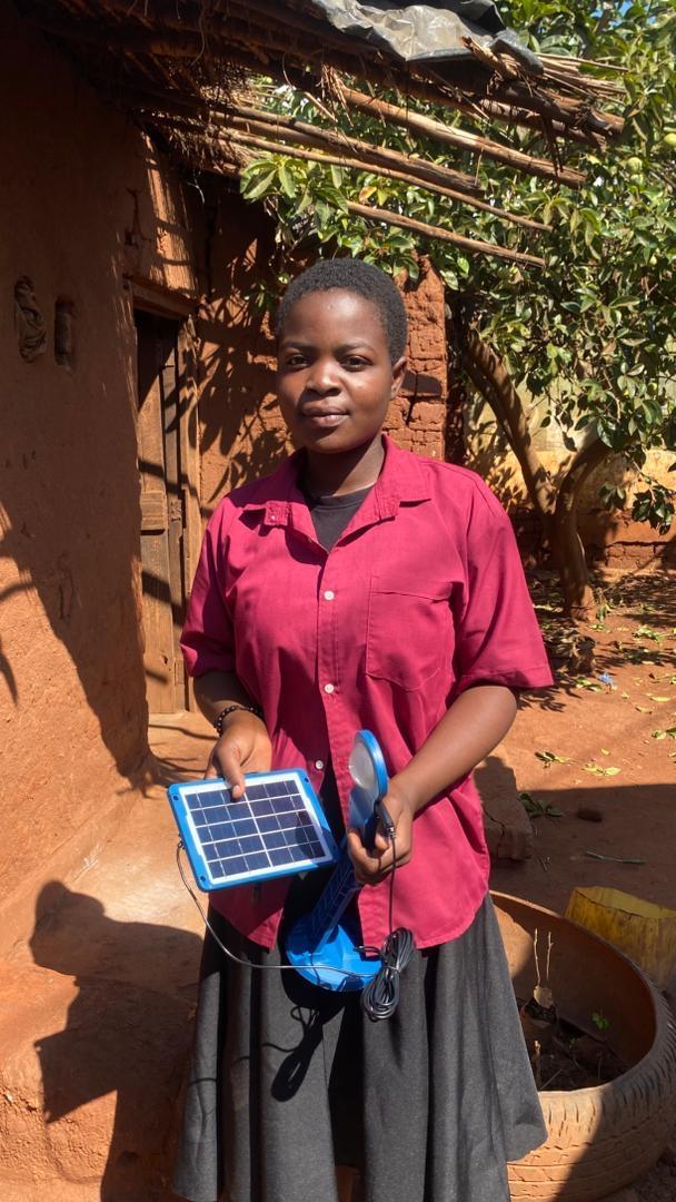 A Form 3 student at Chinsapo Secondary School with her new solar desk lamp
